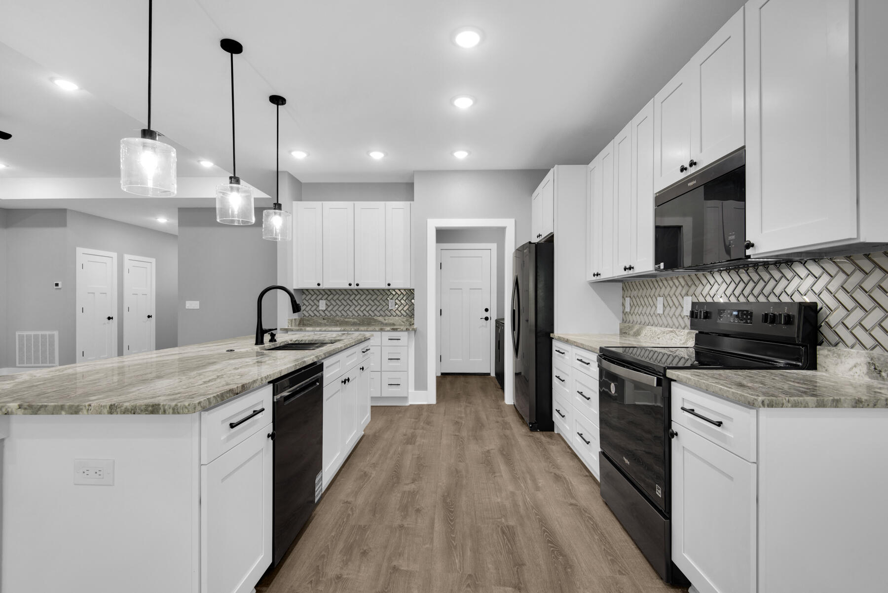 363 Washington Valparaiso, FL 32580 - Photo 13 of 35 a large kitchen with stainless steel appliances kitchen island a large island in the center