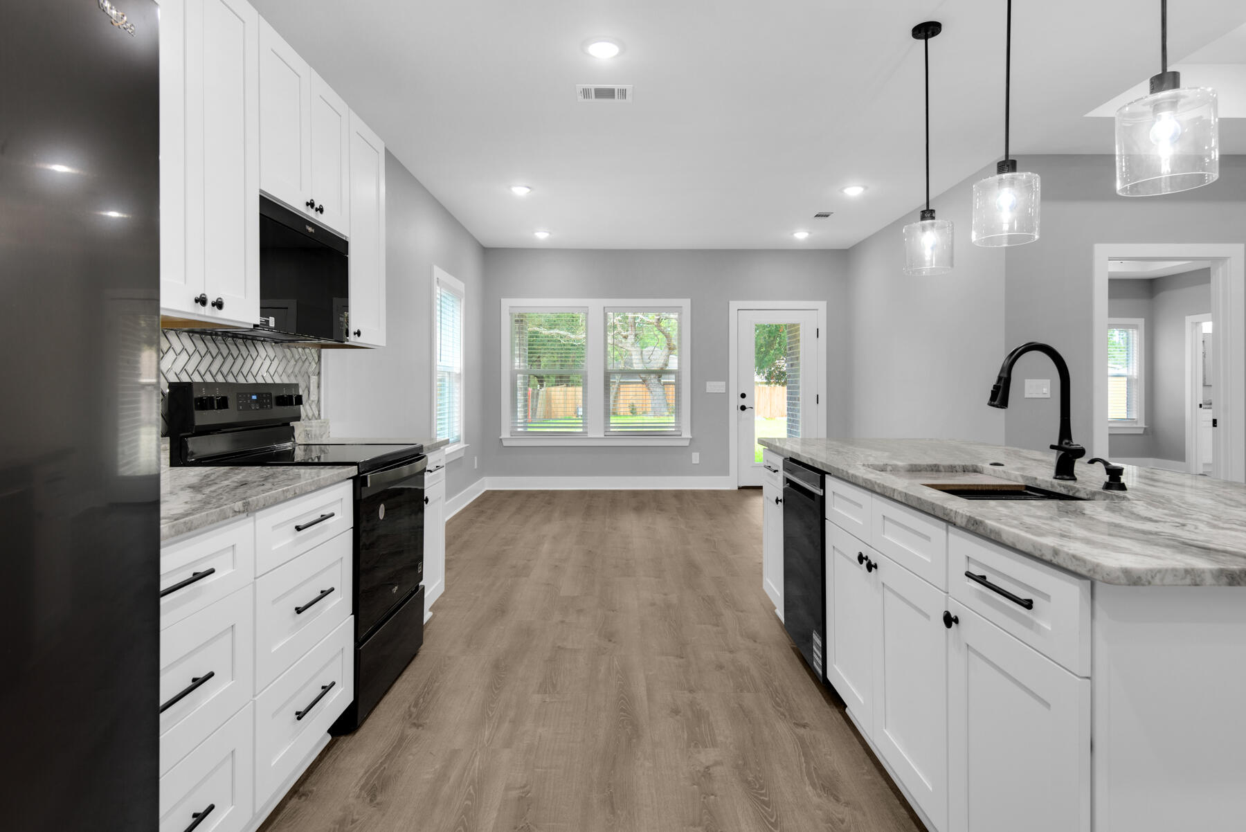 363 Washington Valparaiso, FL 32580 - Photo 17 of 35 a kitchen with granite countertop a sink and a stove top oven