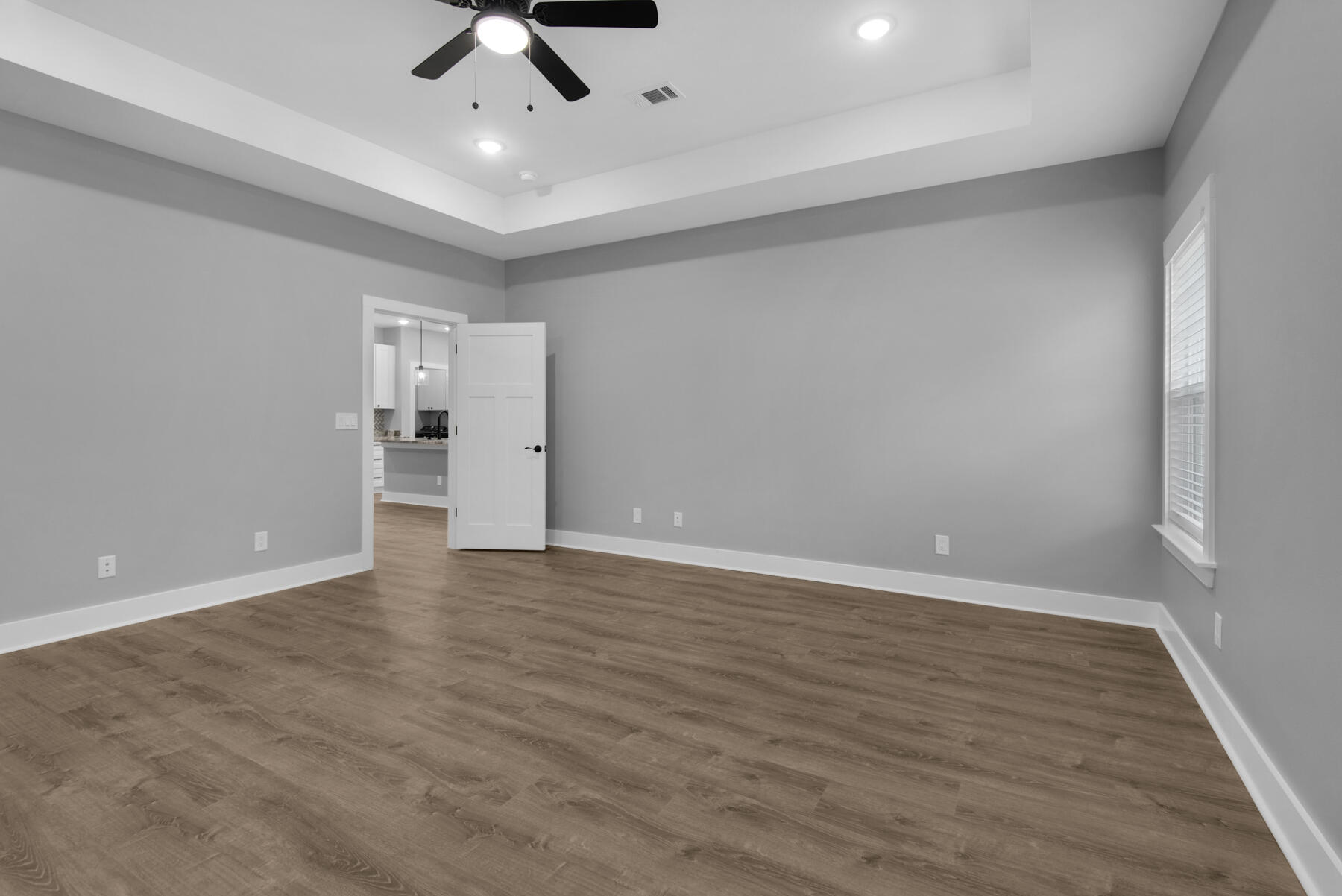 363 Washington Valparaiso, FL 32580 - Photo 23 of 35 wooden floor in an empty room with a ceiling fan