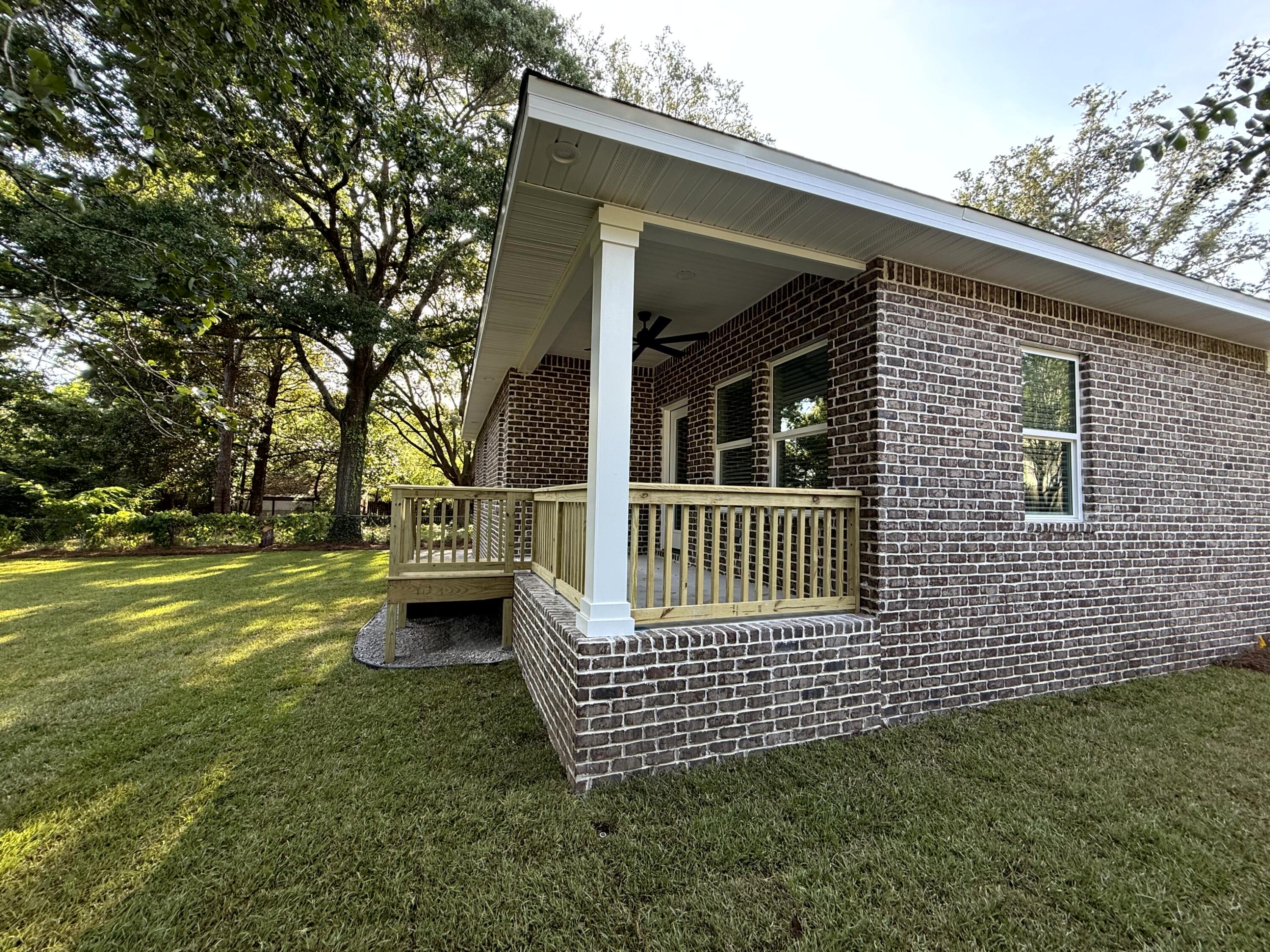 363 Washington Valparaiso, FL 32580 - Photo 3 of 35 a view of a chair and table on the wooden deck