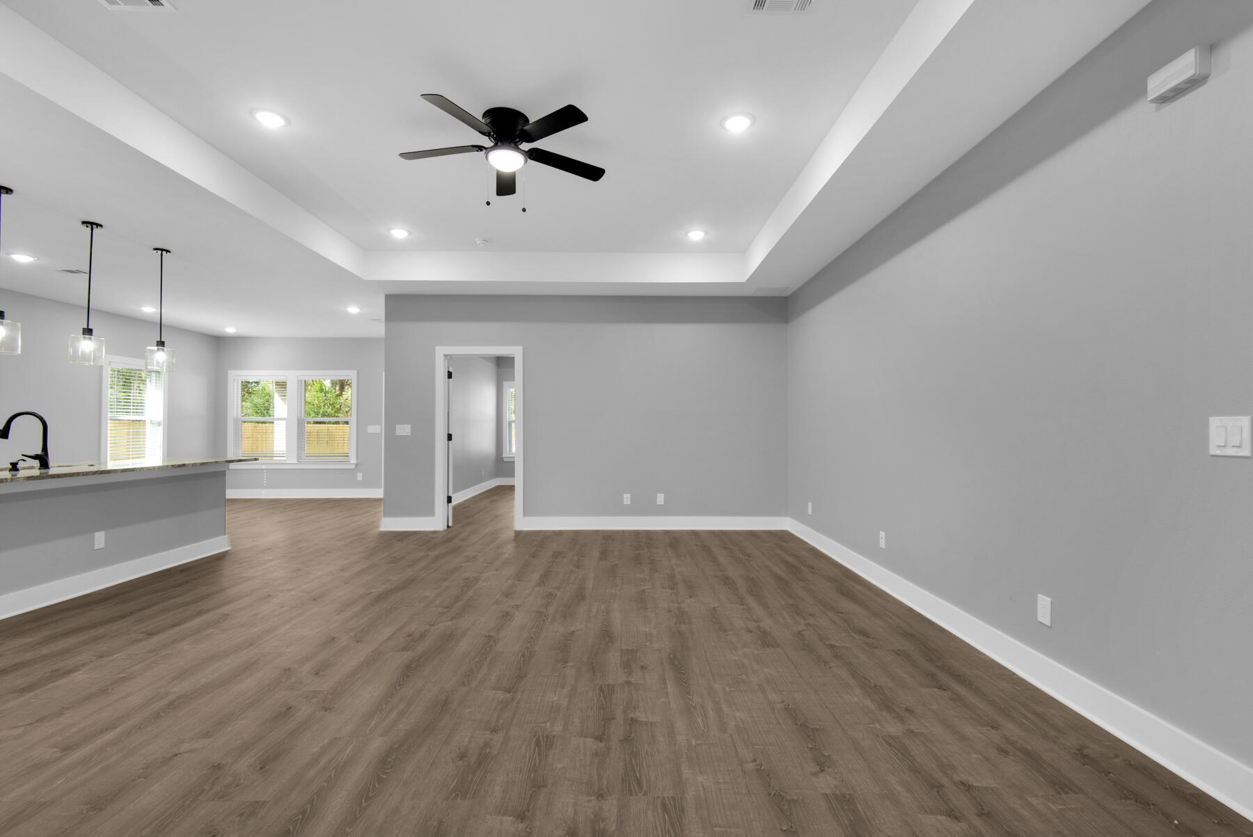 363 Washington Valparaiso, FL 32580 - Photo 8 of 35 an empty room with wooden floor and a ceiling fan