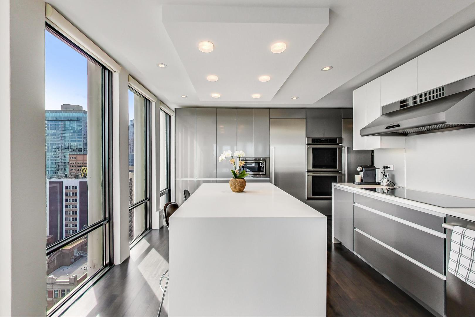 Undisclosed Address Chicago, IL 60611 - Photo 11 of 50 a kitchen with sink refrigerator and microwave