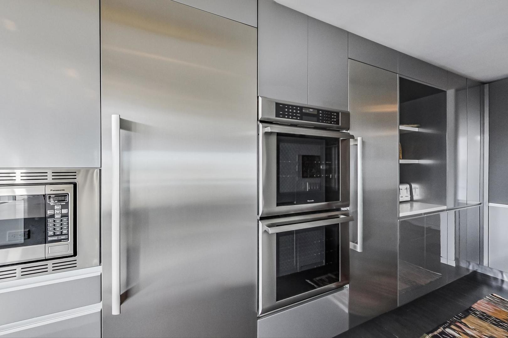 Undisclosed Address Chicago, IL 60611 - Photo 14 of 50 a refrigerator freezer and a stove sitting inside of a kitchen