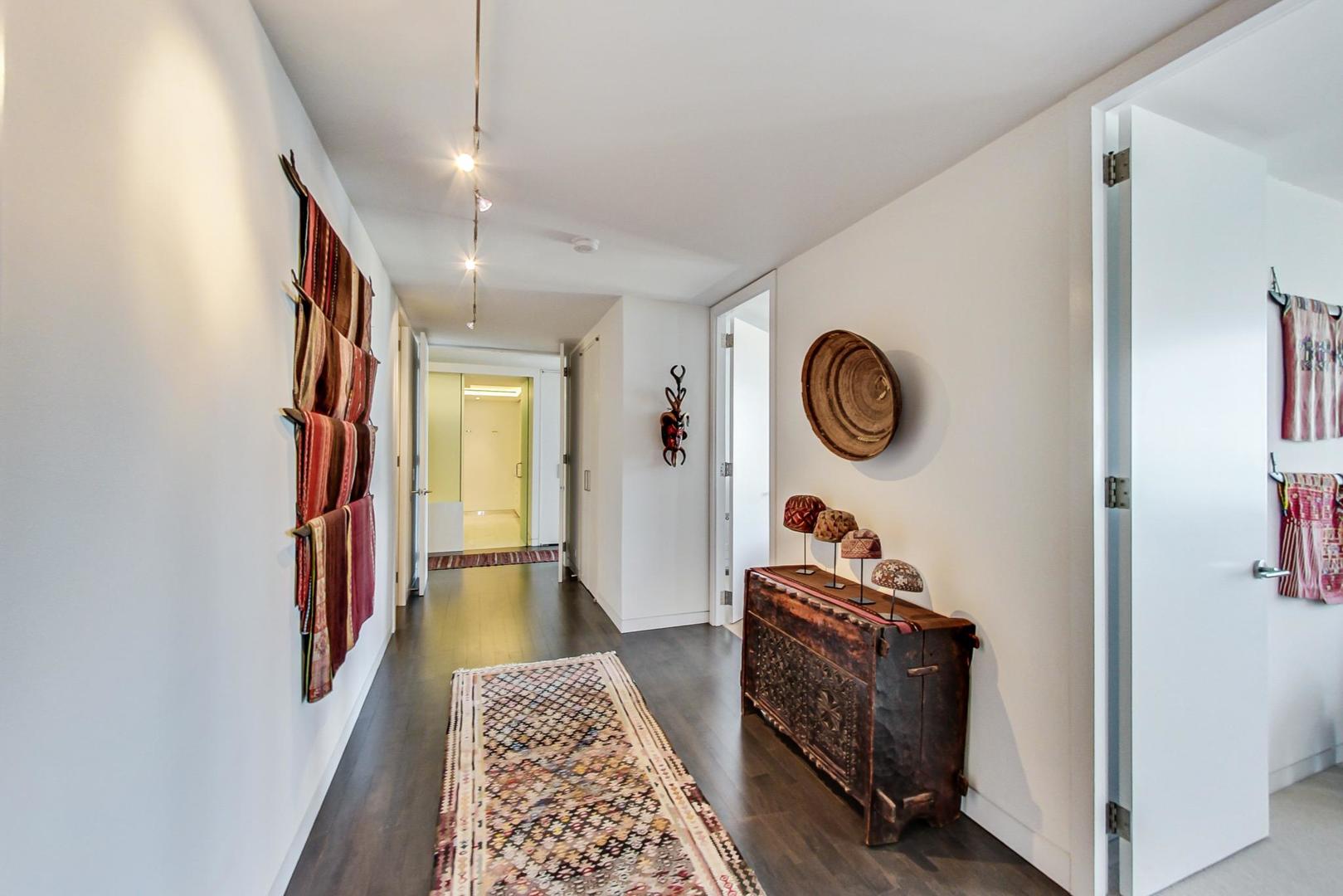 Undisclosed Address Chicago, IL 60611 - Photo 16 of 50 a hallway with painting on the wall and a window