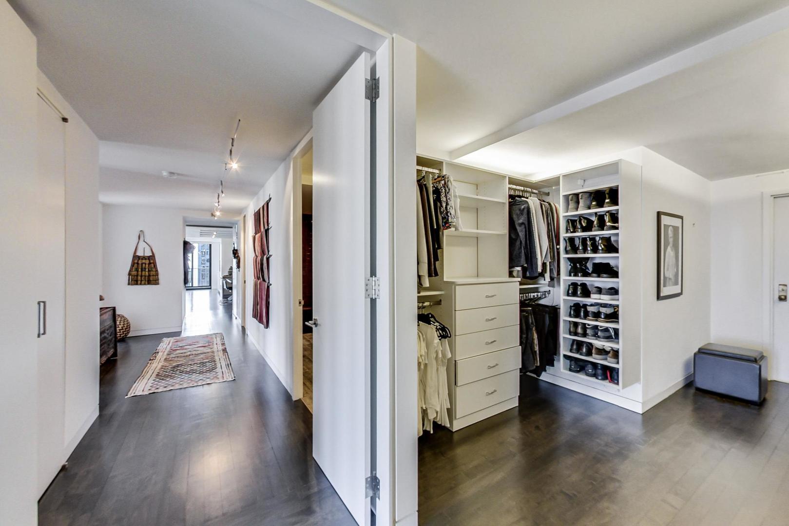 Undisclosed Address Chicago, IL 60611 - Photo 17 of 50 a view of walk in closet with clothes and shoes