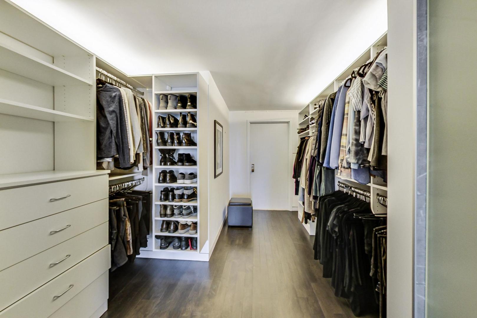 Undisclosed Address Chicago, IL 60611 - Photo 18 of 50 a view of walk in closet with clothes and shoes