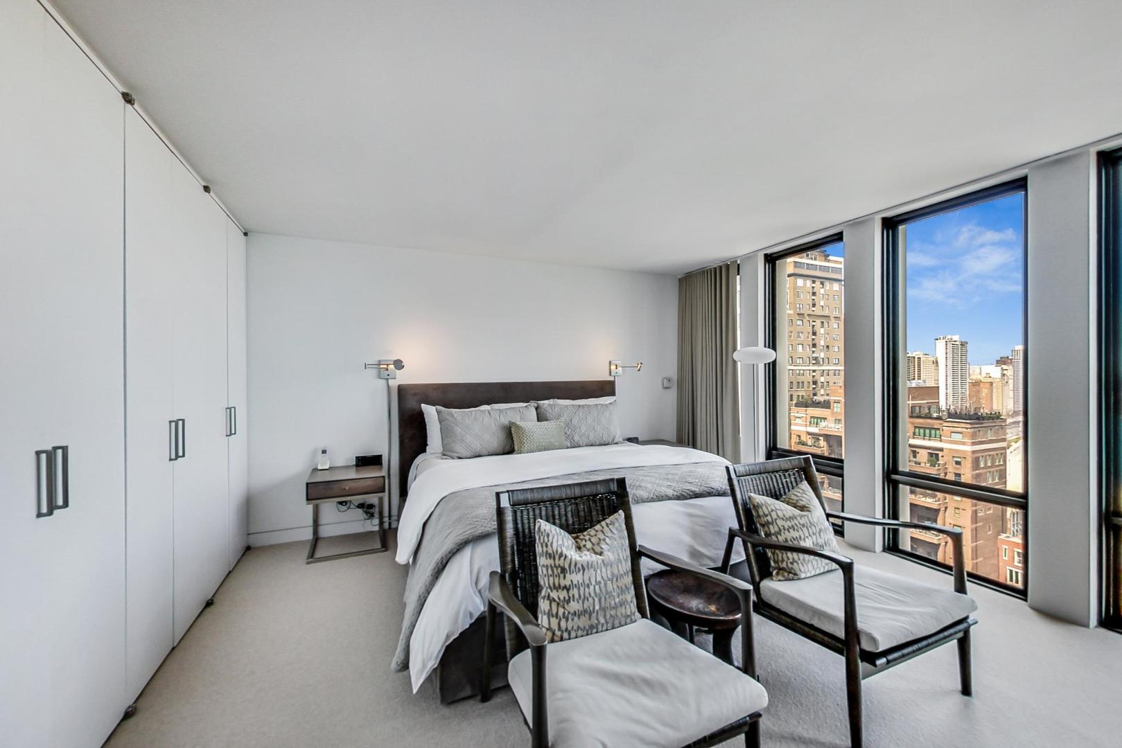 Undisclosed Address Chicago, IL 60611 - Photo 20 of 50 a bedroom with a bed and large windows