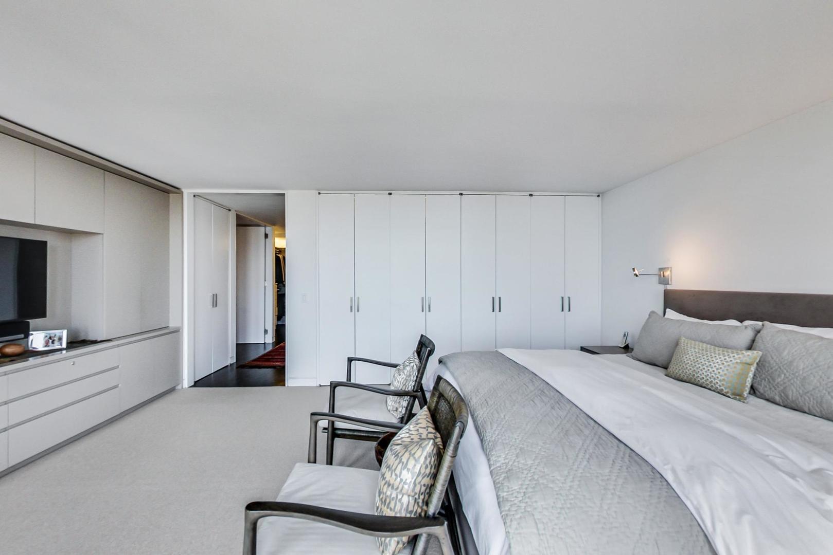 Undisclosed Address Chicago, IL 60611 - Photo 21 of 50 a bedroom with a bed and a flat screen tv