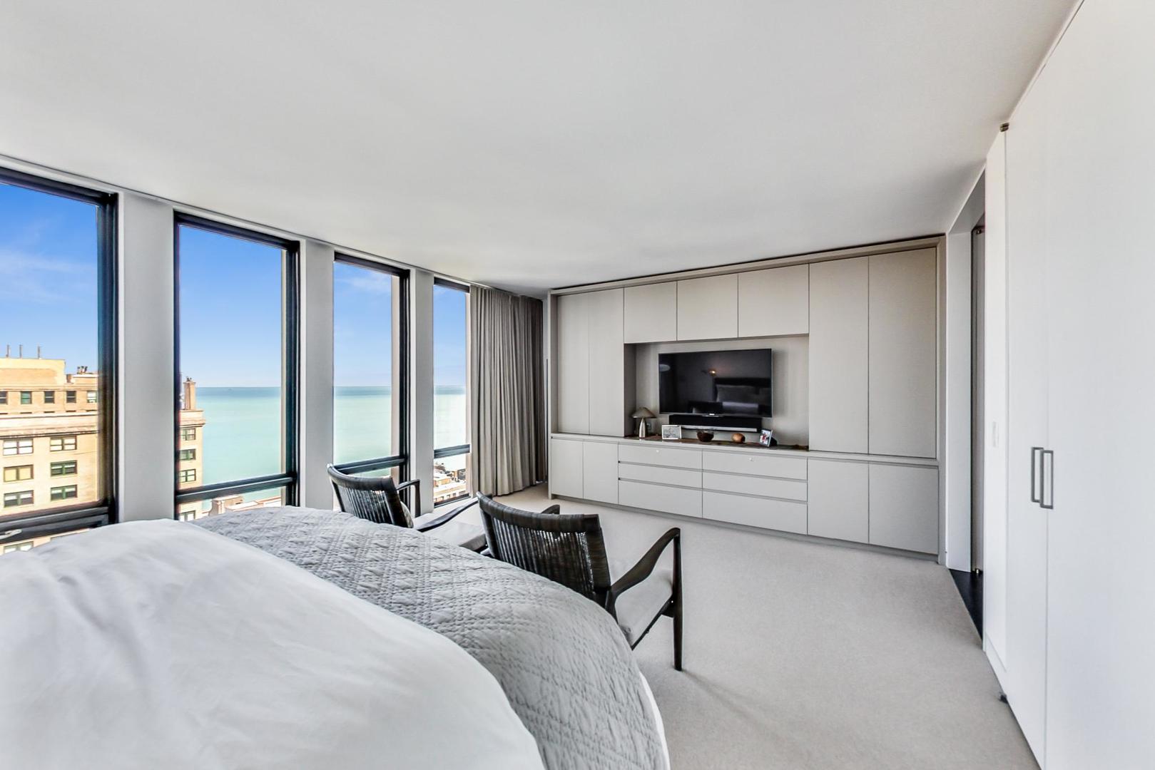 Undisclosed Address Chicago, IL 60611 - Photo 22 of 50 a bedroom with a bed and a flat screen tv