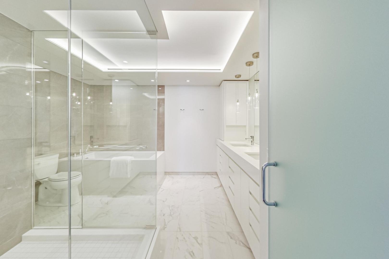 Undisclosed Address Chicago, IL 60611 - Photo 24 of 50 a bathroom with a glass shower door