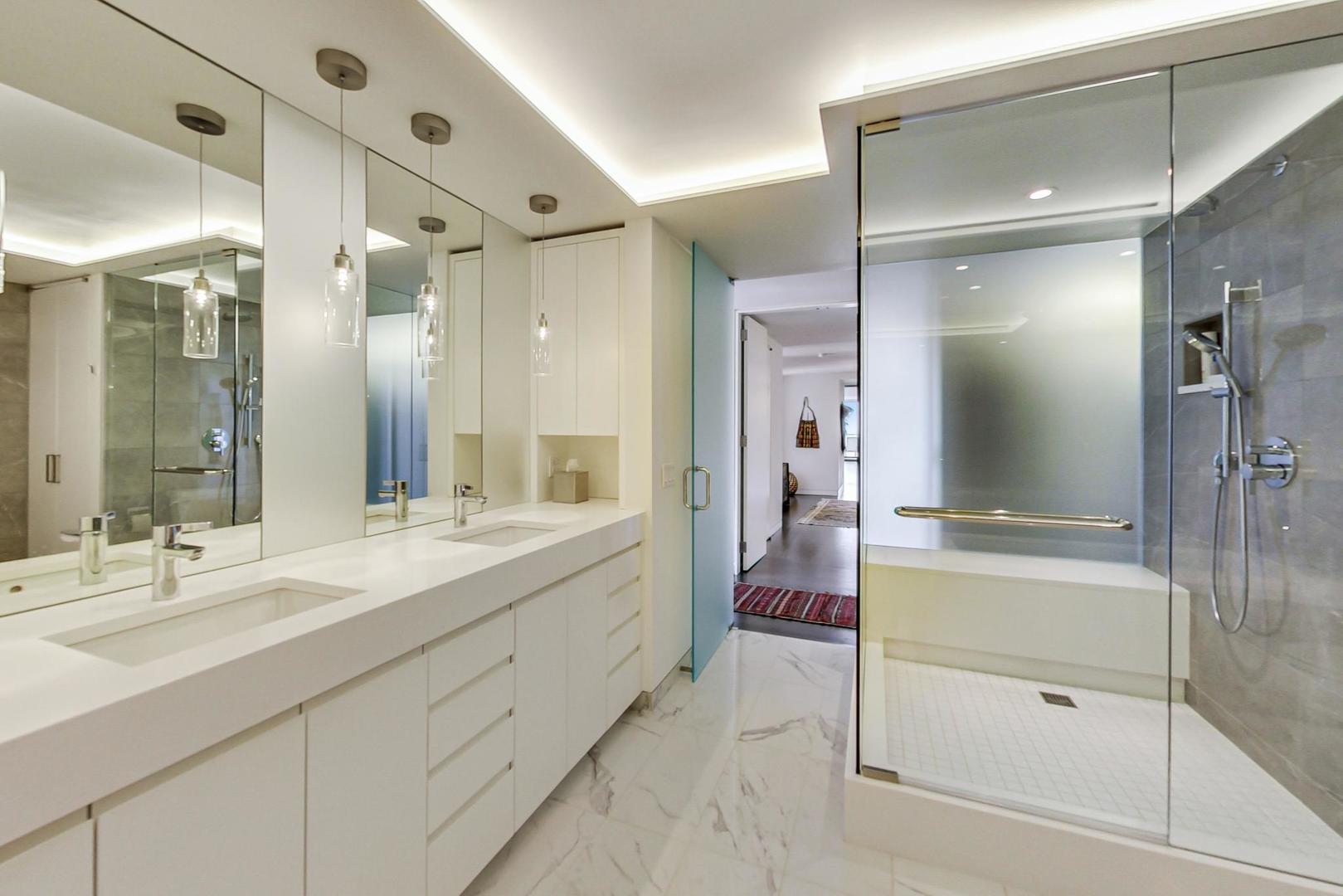 Undisclosed Address Chicago, IL 60611 - Photo 26 of 50 a bathroom with a double vanity sink mirror and shower