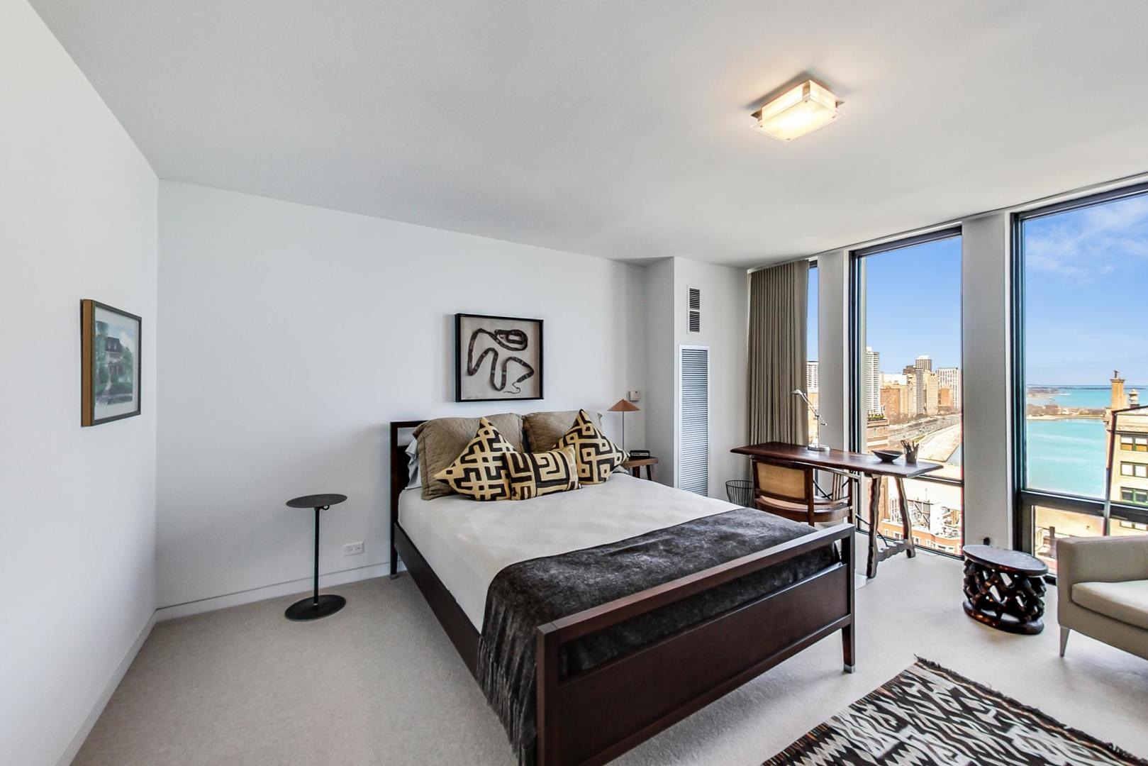 Undisclosed Address Chicago, IL 60611 - Photo 30 of 50 a bedroom with a bed and wooden floor