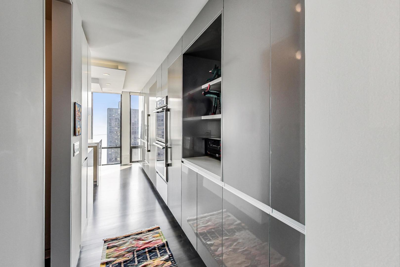 Undisclosed Address Chicago, IL 60611 - Photo 4 of 50 a view of a hallway with wooden floor and staircase