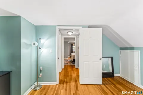 a view of hallway with wooden floor