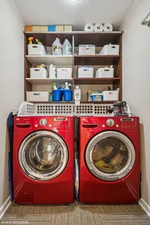 a utility room with wooden toilet and racks