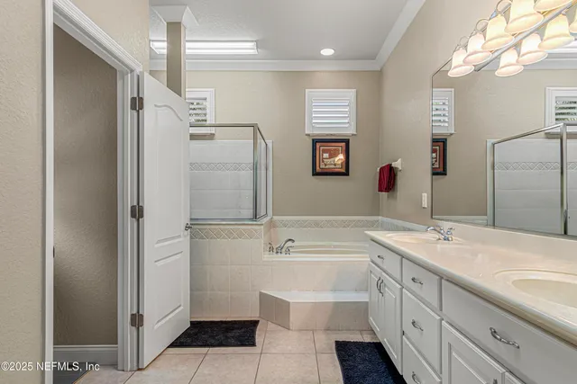 a bathroom with a double vanity sink mirror and shower