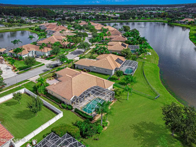 an aerial view of a house with garden space and lake view