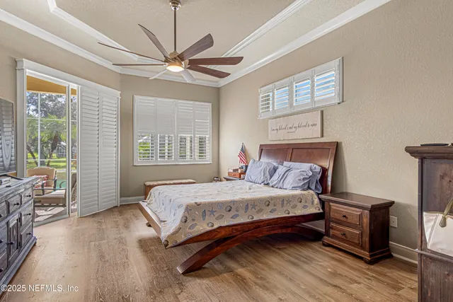 a bedroom with a bed wooden floor and window