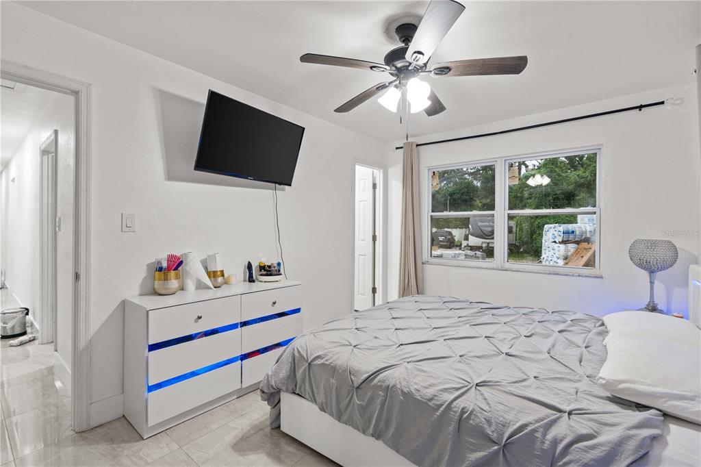 13002 East Wheeler Road Dover, FL 33527 - Photo 12 of 22 a bedroom with a bed and a flat screen tv