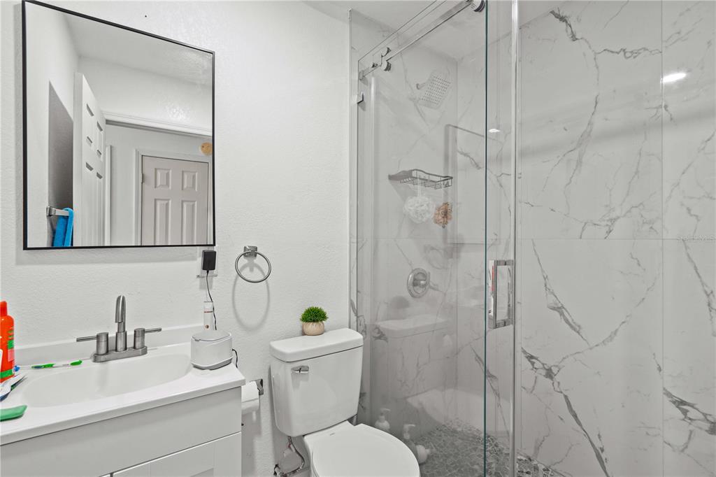 13002 East Wheeler Road Dover, FL 33527 - Photo 14 of 22 a bathroom with a sink toilet and shower