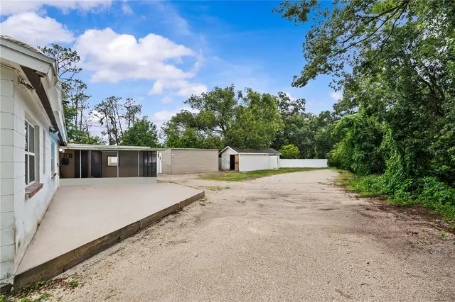 a pathway of a house with a yard