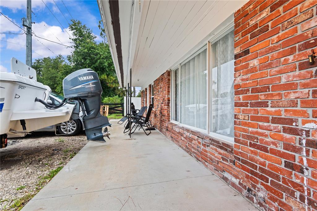13002 East Wheeler Road Dover, FL 33527 - Photo 2 of 22 a view of a house with a patio and a yard