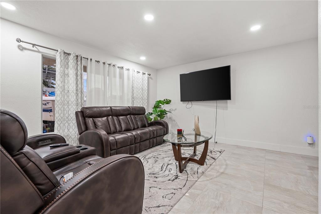 13002 East Wheeler Road Dover, FL 33527 - Photo 5 of 22 a living room with furniture and a flat screen tv