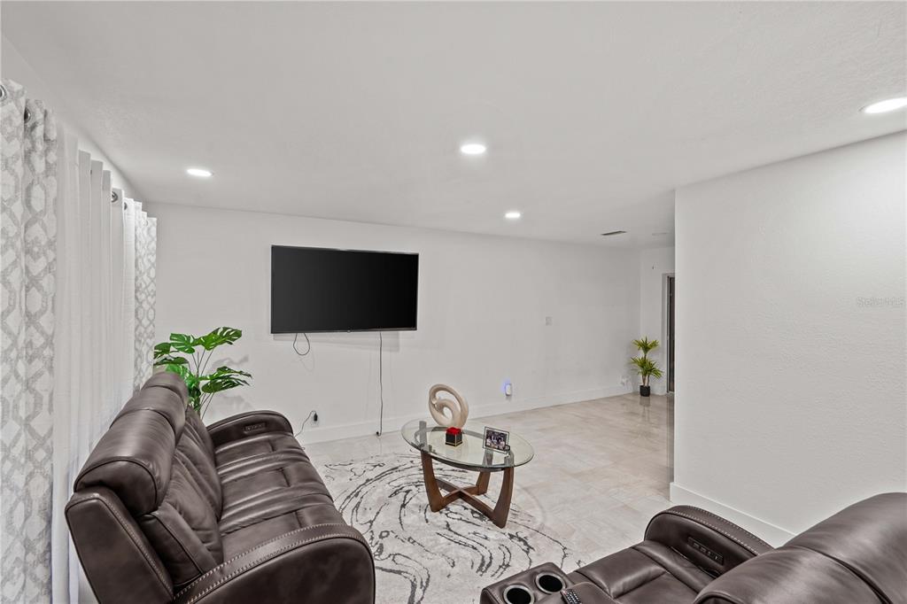 13002 East Wheeler Road Dover, FL 33527 - Photo 6 of 22 a living room with furniture and a flat screen tv
