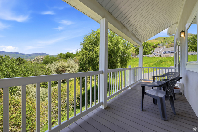 3766 Cardiff Circle Bountiful, UT 84010 - Photo 17 of 46 Covered porch featuring a grey deck, white railing, and white support columns