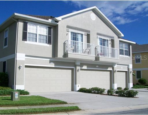 8449 Shallow Creek Court New Port Richey, FL 34653 - Photo 1 of 1 a front view of a house with a yard and garage