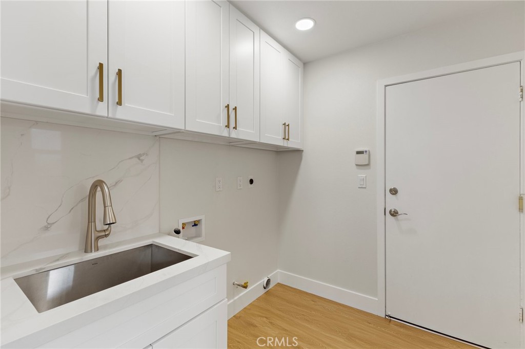 7848 Calmcrest Drive Downey, CA 90240 - Photo 33 of 36 Spacious laundry room with plenty of storage and sink