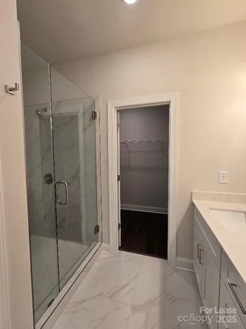 a bathroom with a shower and sink