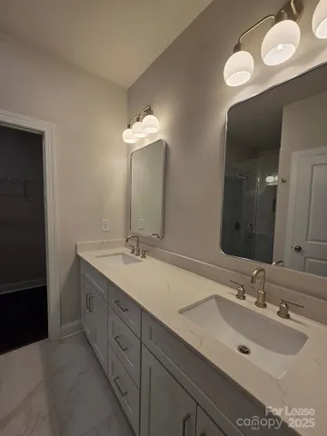 a bathroom with a double vanity sink and a mirror
