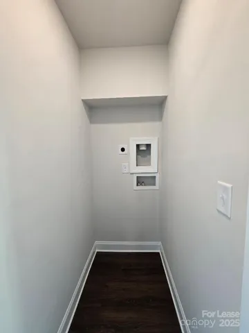 a view of a room with wooden floor and white walls
