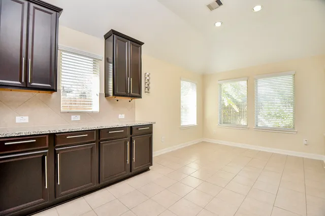 a view of a livingroom with a kitchen and a fireplace