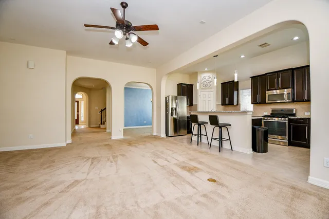a kitchen with stainless steel appliances a sink stove and cabinets
