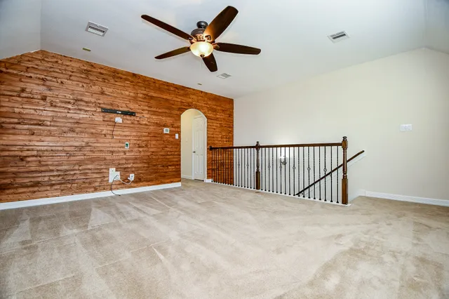 a view of a room with a ceiling fan