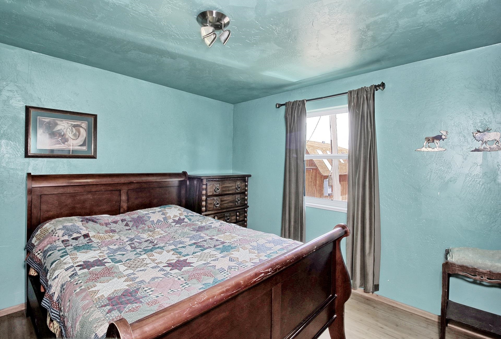 990 T Road Mack, CO 81525 - Photo 14 of 42 a bed sitting in a bedroom next to a window