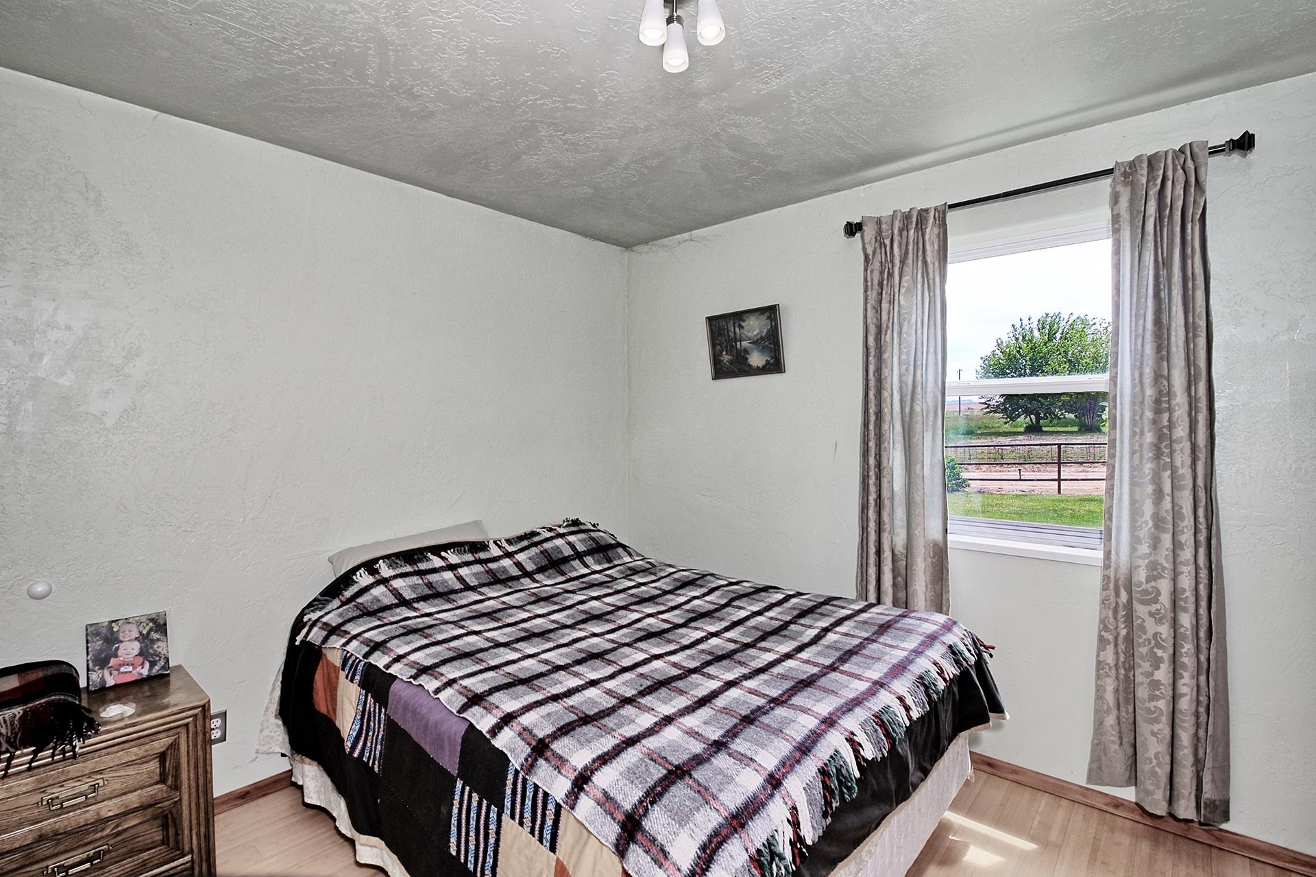 990 T Road Mack, CO 81525 - Photo 17 of 42 a bedroom with a bed and a window