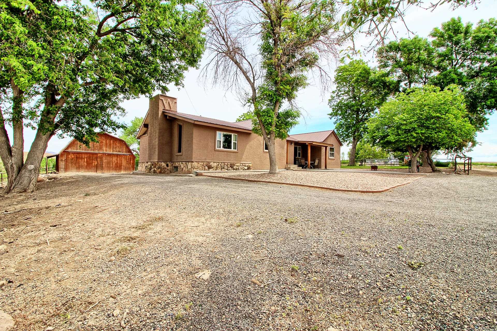 990 T Road Mack, CO 81525 - Photo 3 of 42 a front view of a house with a yard
