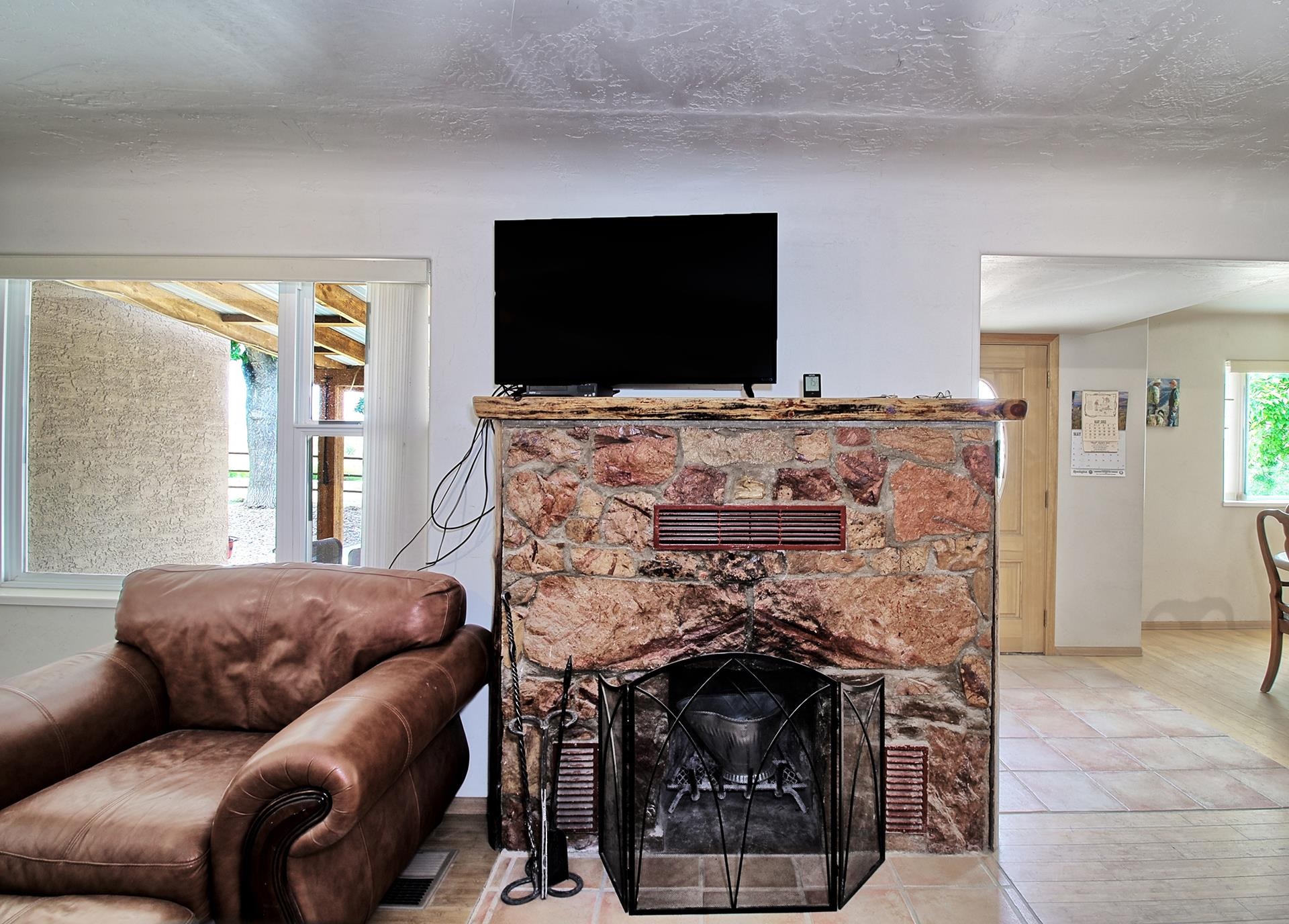 990 T Road Mack, CO 81525 - Photo 6 of 42 a living room with furniture a flat screen tv and a fireplace