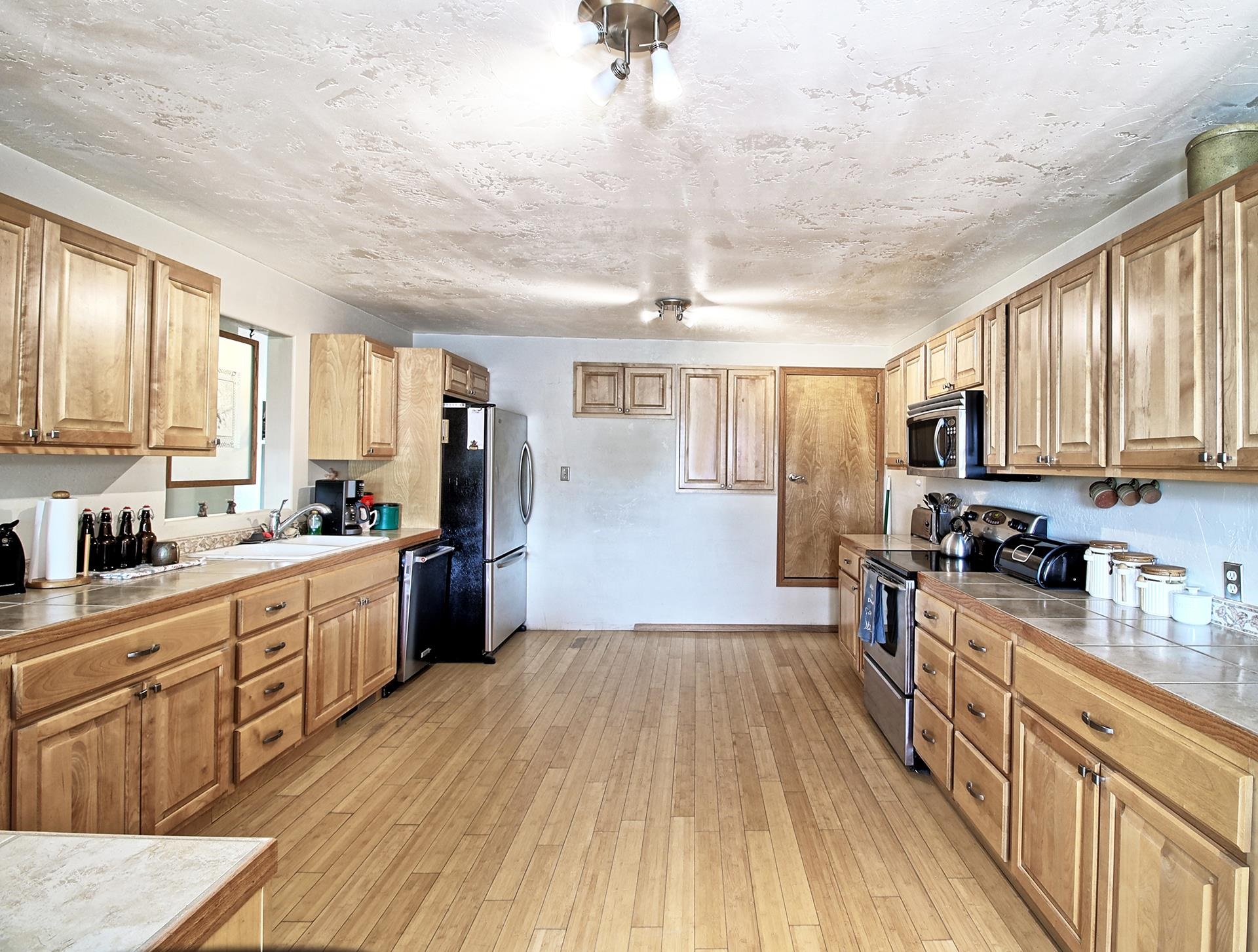 990 T Road Mack, CO 81525 - Photo 7 of 42 a large kitchen with a lot of counter space and wooden floor