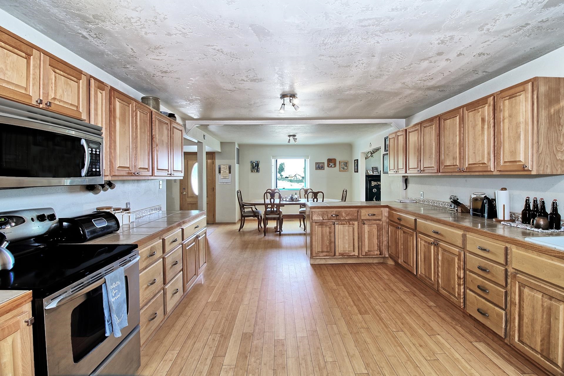 990 T Road Mack, CO 81525 - Photo 8 of 42 a kitchen with stainless steel appliances granite countertop wooden cabinets a stove top oven a sink and dishwasher with wooden floor