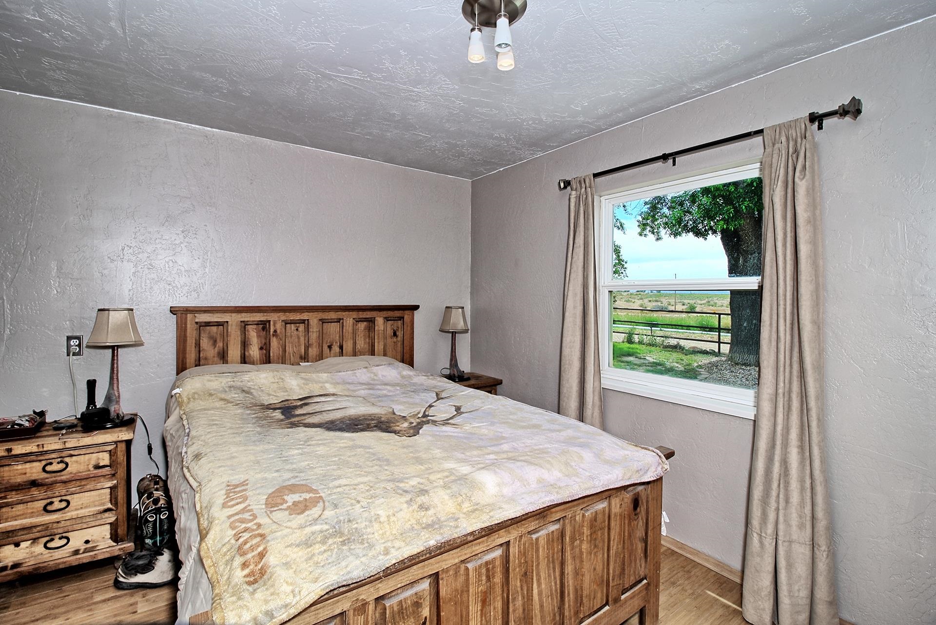 990 T Road Mack, CO 81525 - Photo 10 of 42 a bedroom with a bed and a window