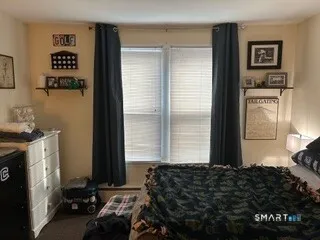 a bedroom with a bed and a window