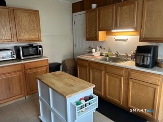 202 Berlin Avenue Southington, CT 06489 - Photo 21 of 26 a kitchen with stainless steel appliances granite countertop a sink stove and cabinets