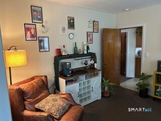 202 Berlin Avenue Southington, CT 06489 - Photo 25 of 26 a living room with furniture and a flat screen tv