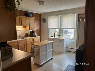 202 Berlin Avenue Southington, CT 06489 - Photo 3 of 26 a kitchen with a sink stove and cabinets