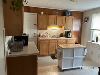 a kitchen with a sink a stove and refrigerator
