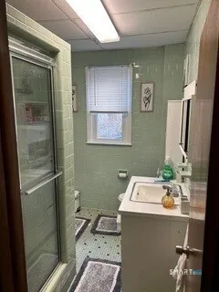 a bathroom with a sink toilet and shower